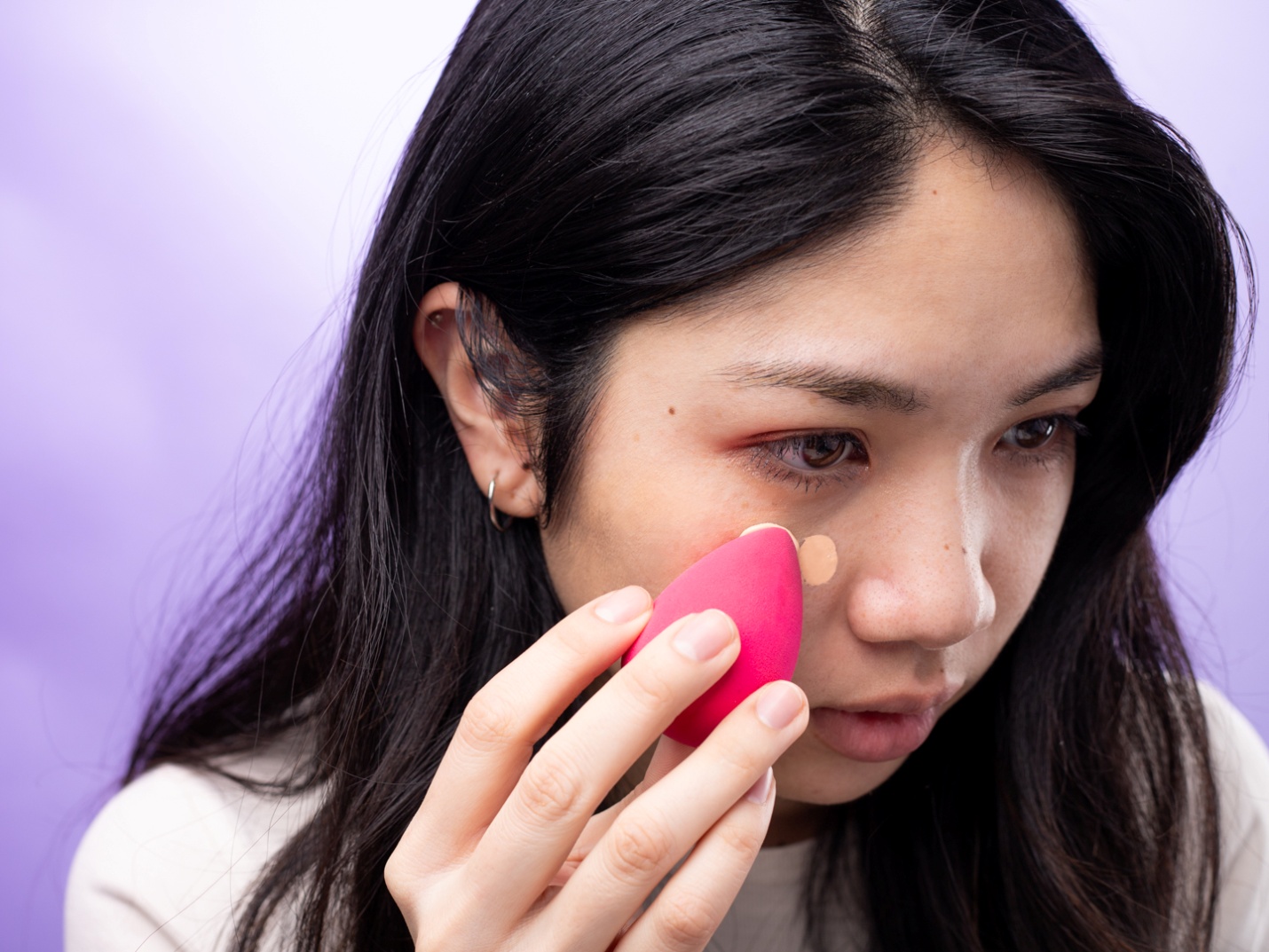 Applying foundation with damp beauty blender